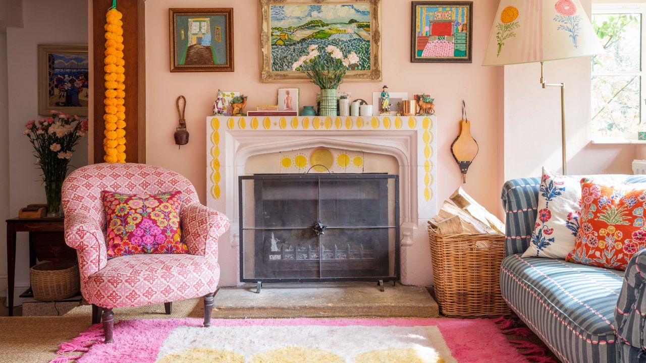 eclectic living room ideas colorful living room with pink and yellow rug, blue patterned couch, cushions, pink upholstered chair, artwork, fireplace that&#039;s painted, paint