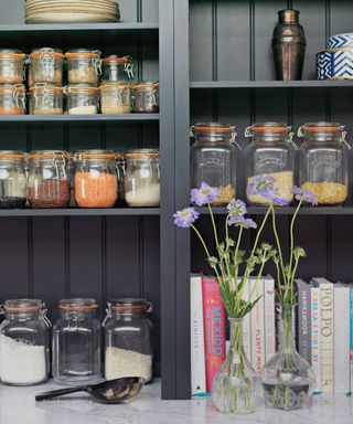 black open shelving with board and batten and lots of glass kilner jars