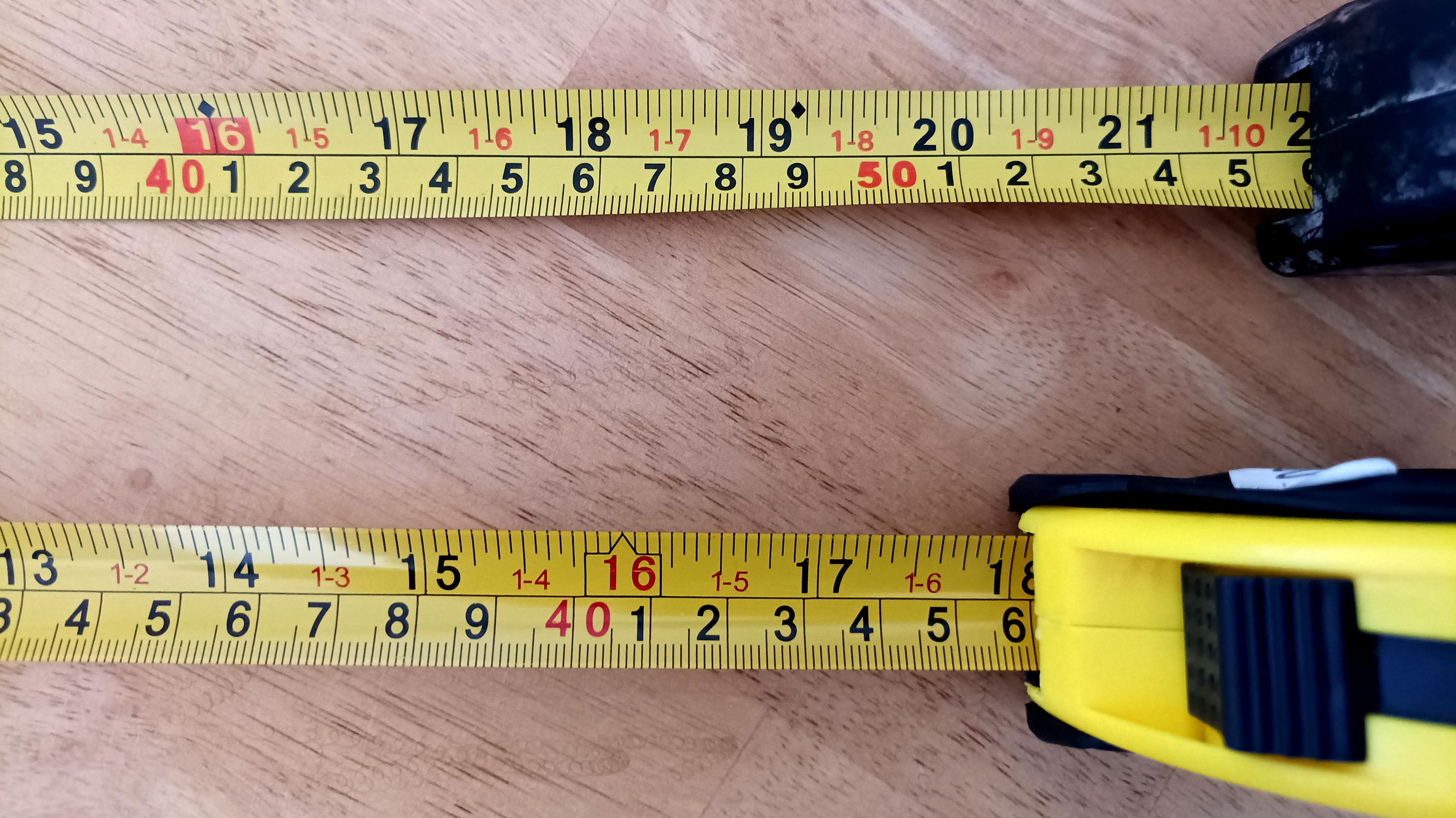 Top down view of two Imperial/Metric tape measures side by side