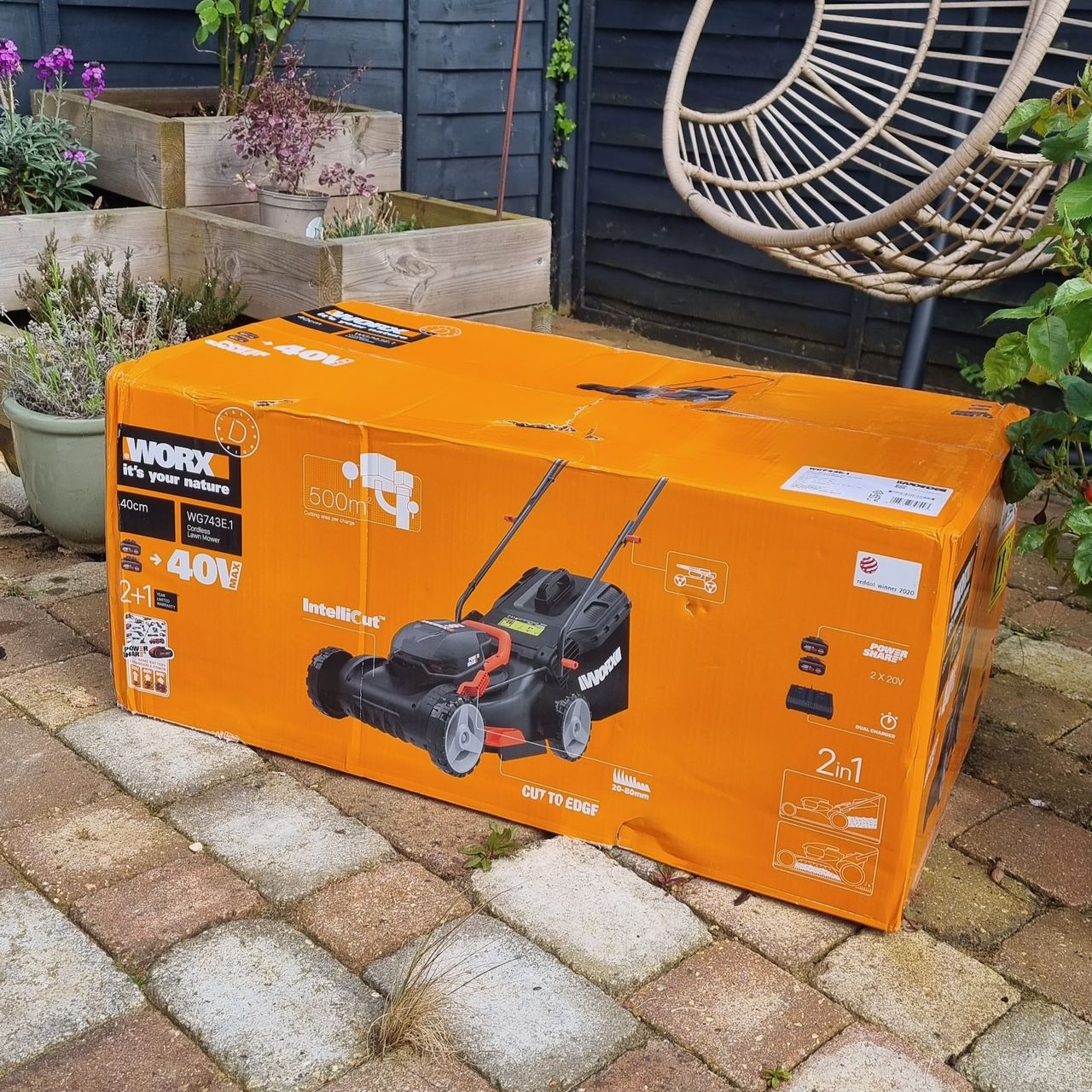 Worx WG743E lawn mower boxed on paving