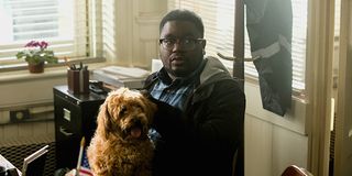 Lil Rel Howery holding a dog in Jordan Peele's Get Out