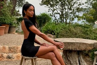Laura Harrier in a black backless mini dress by Reformation