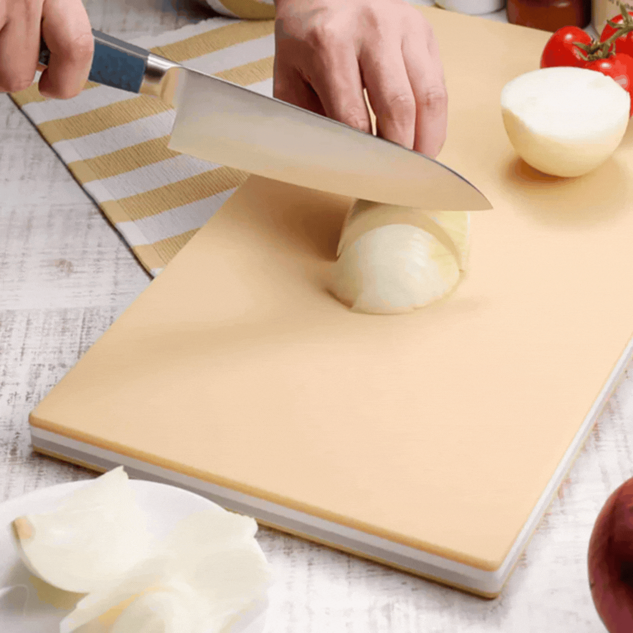 Hasegawa Wood Core Soft Chopping Board shown in a rotating gif in a lifestyle shot where it's being used and as a product image against pale green background.