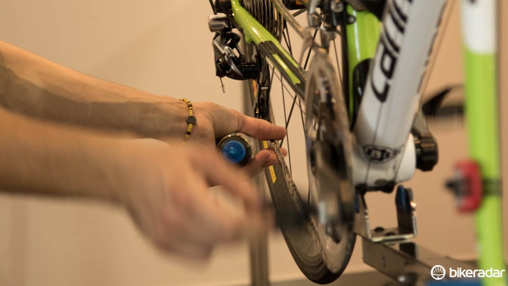 Chain lube is forced through the rollers with a bit of help. This also helps the mechanic feel for imperfections in the chain, such as a bent link