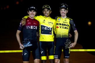 Egan Bernal stands between Geraint Thomas and Steven Kruijswijk