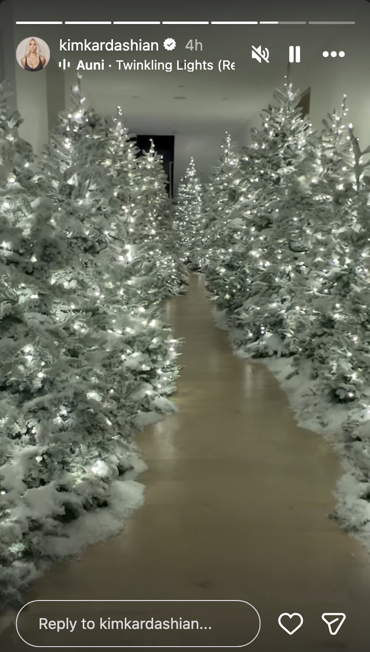 Kim Kardashian shows off her hallway of Christmas trees on Instagram Stories.
