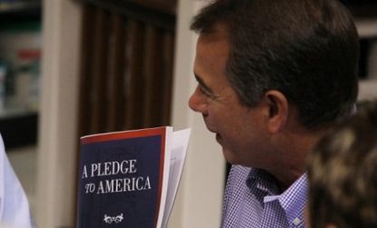 John Boehner shows off the "Pledge To America" during an unveiling event hosted by Tart Lumber in Sterling, Virginia. 
