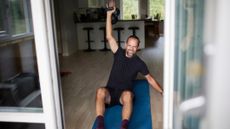 Man exercising with kettlebell at home