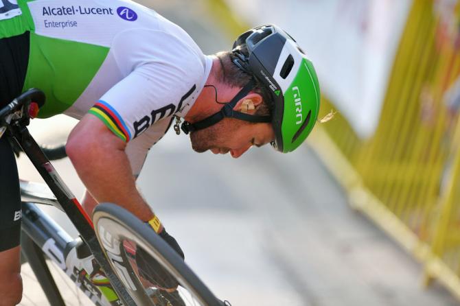 Mark Cavendish works on his bike after crashing near the finish of stage 1 at Tour de Pologne
