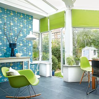 Conservatory with bright green chairs and blinds and blue and green decorative blinds