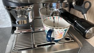coffee machine pouring coffee into mug