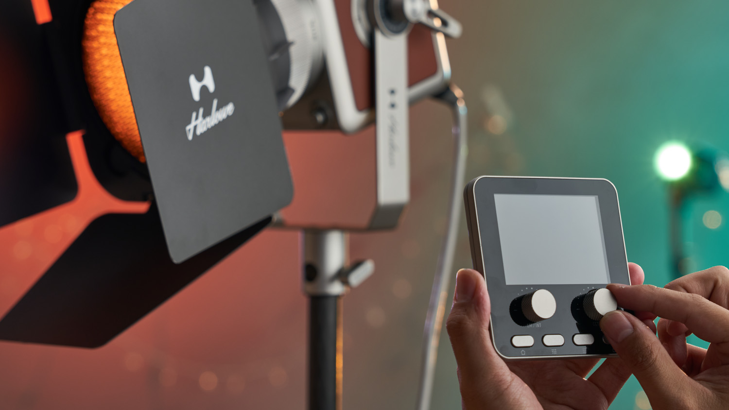 Harlowe Pro 300 Spectra being controlled by remote controller in hand