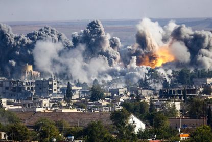 Smoke rises over Syrian town of Kobani after an airstrike.