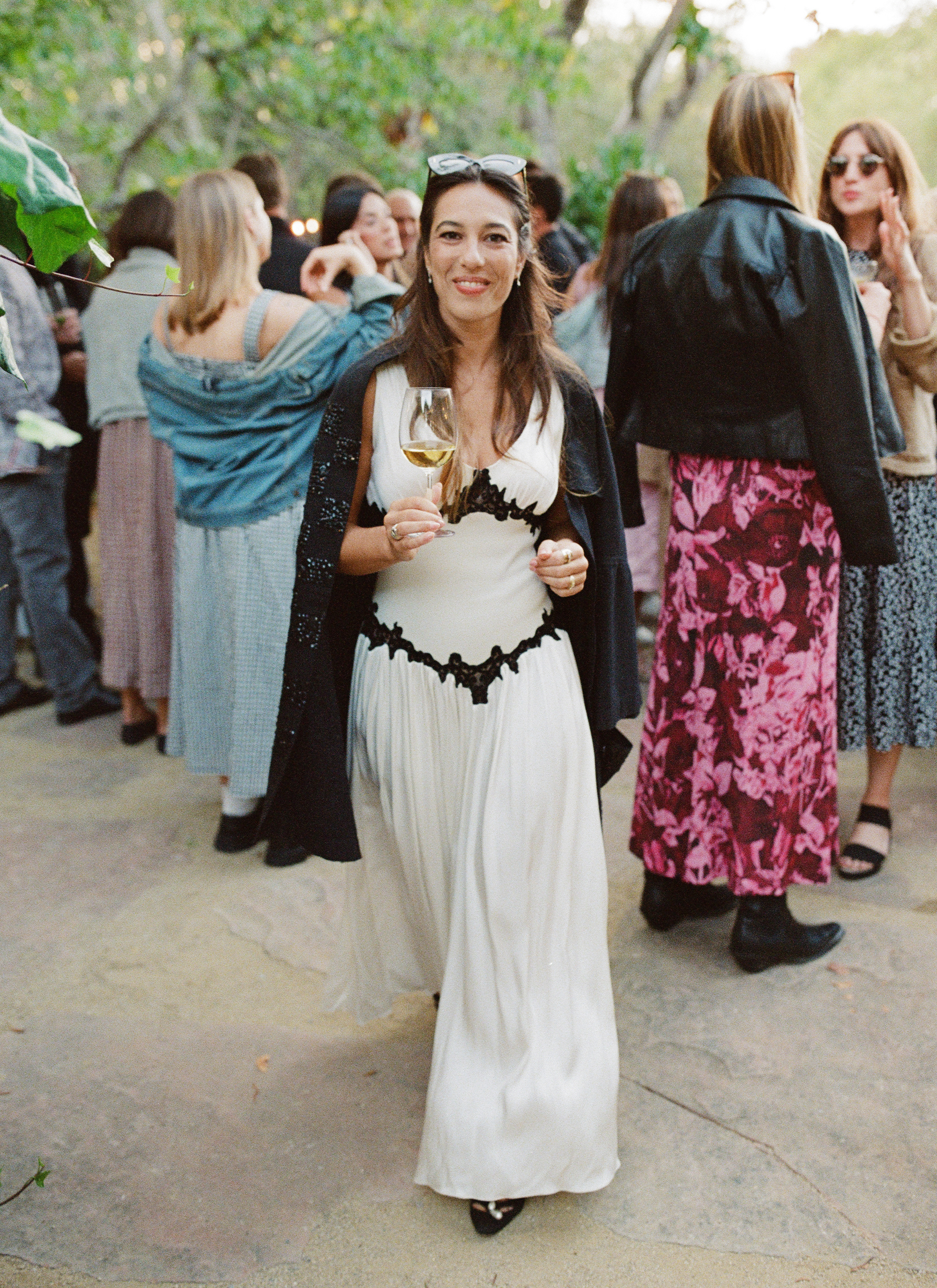 Hadley wears a white dress with black lace for the welcome party.