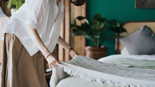 Woman making her bed