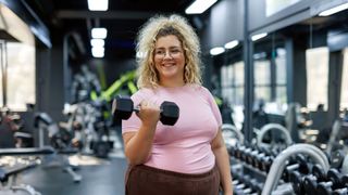 Woman holding dumbell in hand