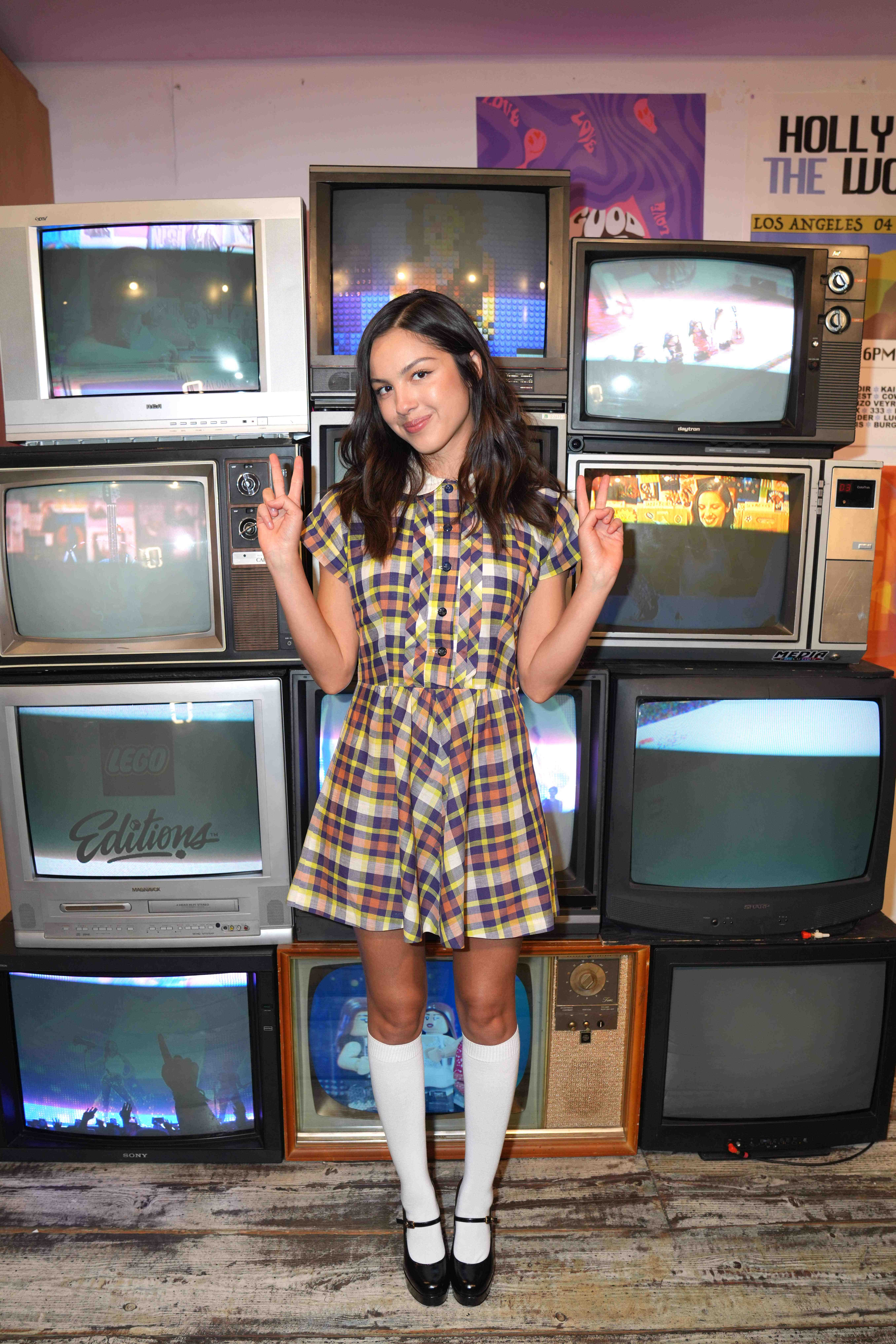 Olivia Rodrigo styles the babydoll dress trend with socks and heeled Mary Janes