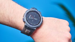 A black and gray Amazfit Active Edge GPS fitness tracker on a person's wrist