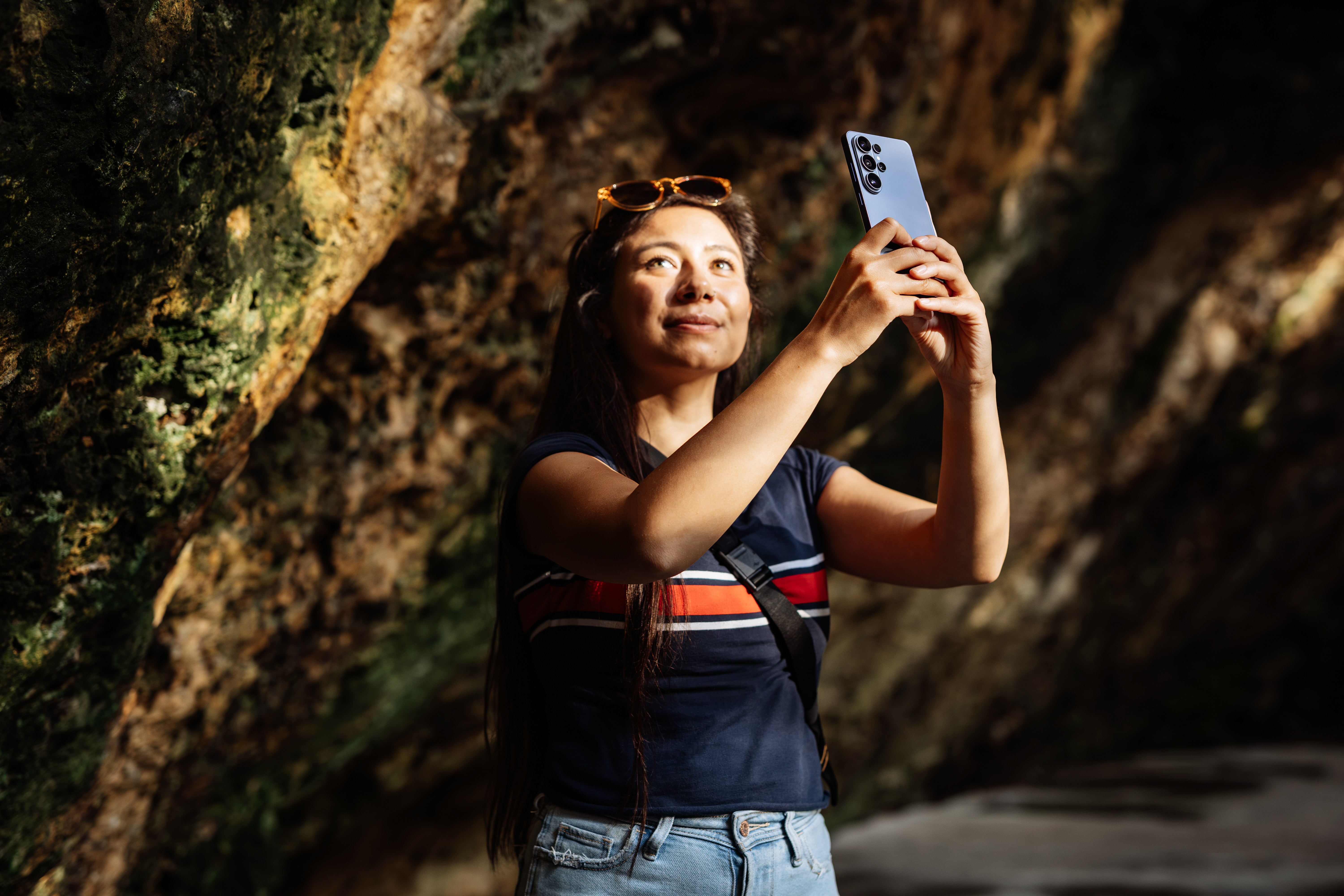 girl takes photo in dark cave with phone