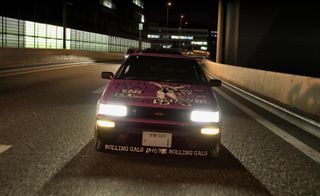 A decorated purple car speeding head-on down a road in Toyko Xtreme Racer