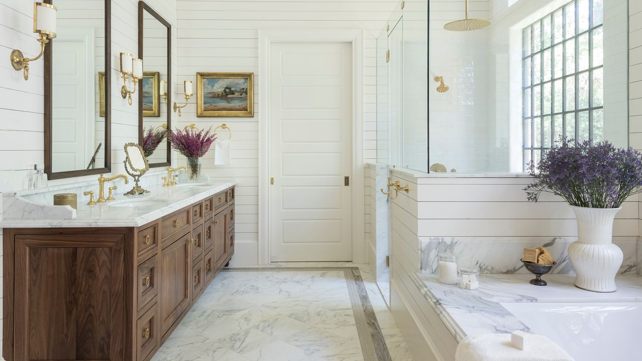 a bathroom with a shower enclosed in a pony wall