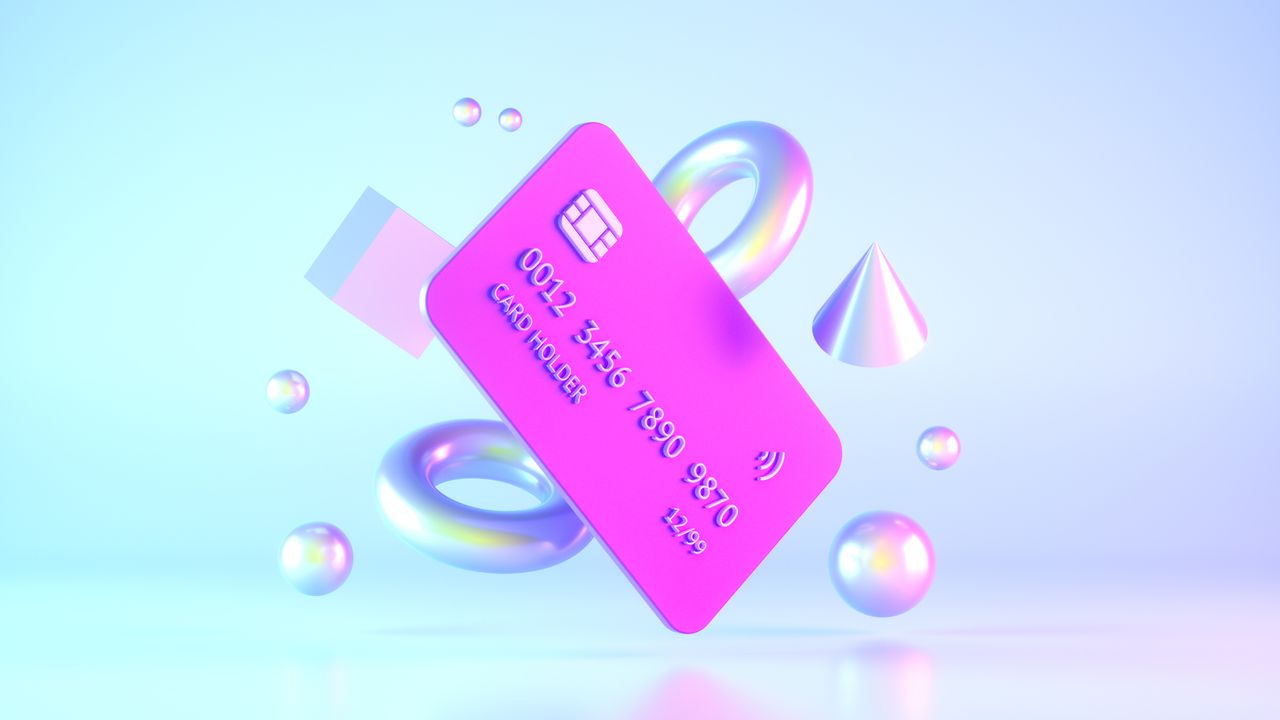 Credit card floating alongside luminous shapes