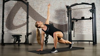 Woman in workout gear exercising in empty gym space