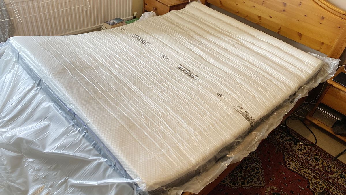 Nectar Premier Hybrid mattress in plastic, unexpanded on a bed