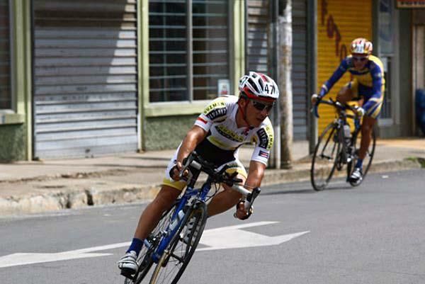 Two riders are near each other on this corner.