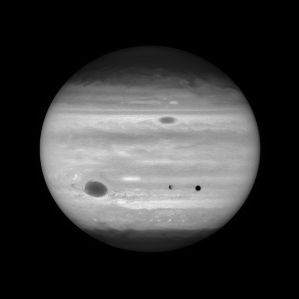 Hubble time-lapse sequence of images showing Europa crossing in front of Jupiter while Jupiter moves and rotates behind Europa. This image is taken in near ultraviolet light.