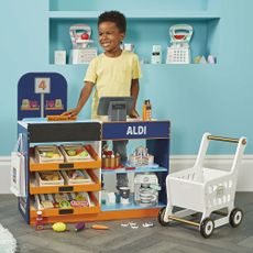 little boy with toy and blue wall