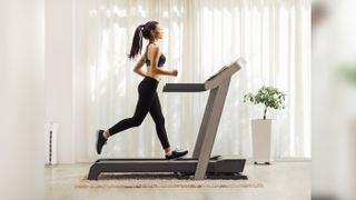 Cyber Monday treadmill deals can save you some cash. Here, a woman jogs on a home treadmill.