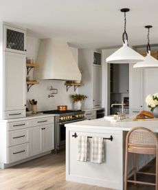 A white kitchen refreshed for spring with light blue tea towels