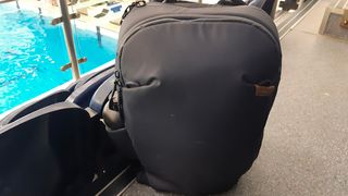 Peak Design Travel backpack by the side of a swimming pool