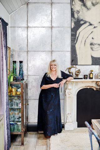 Jo Wood pictured by fireplace with Marilyn Monroe painting above