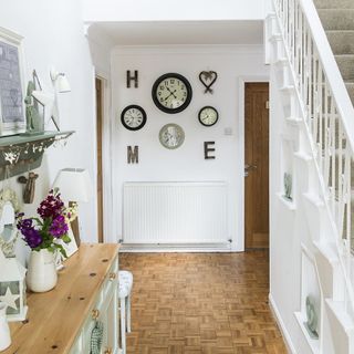 room with wooden flooring and clock on wall