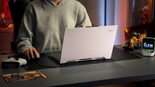 Asus TUF Dash F15 (2022) being used by a gamer at a desk.