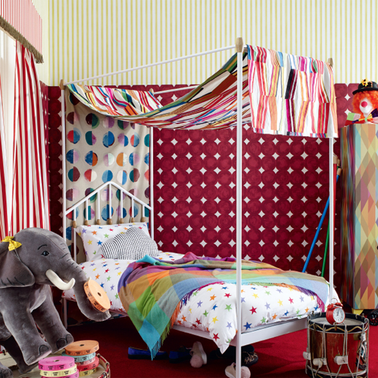 bedroom with geometric pattern printed wall and white bed with stand