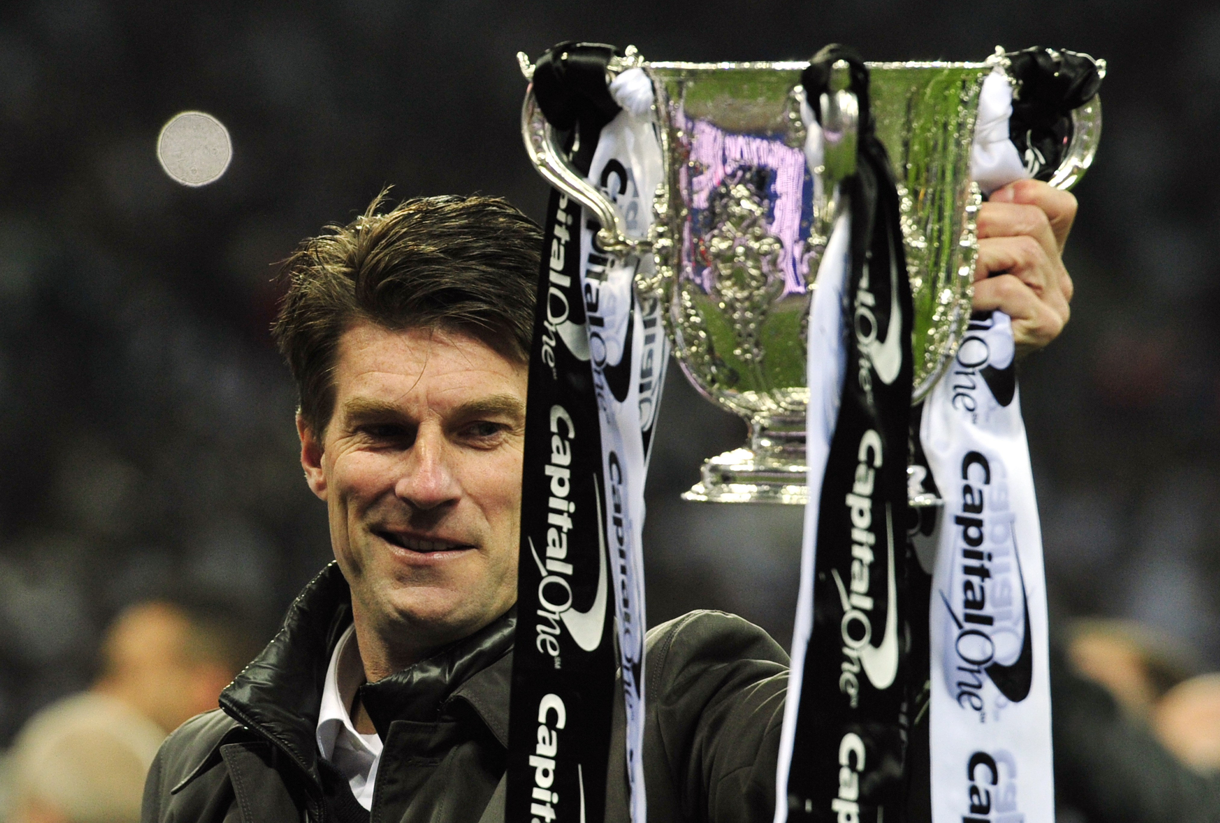 Michael Laudrup celebrates with the League Cup trophy after Swansea's win over Bradford City in the 2013 final.