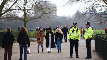 Metropolitan Police officers patrol as people walk in Hyde Park