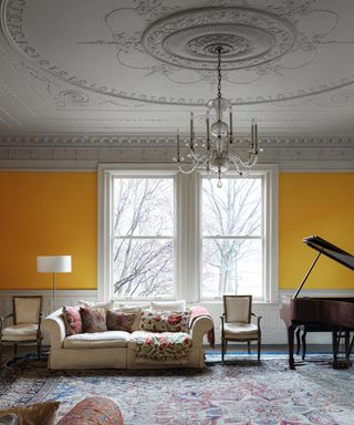 Yellow living room, white window frame, cream sofa