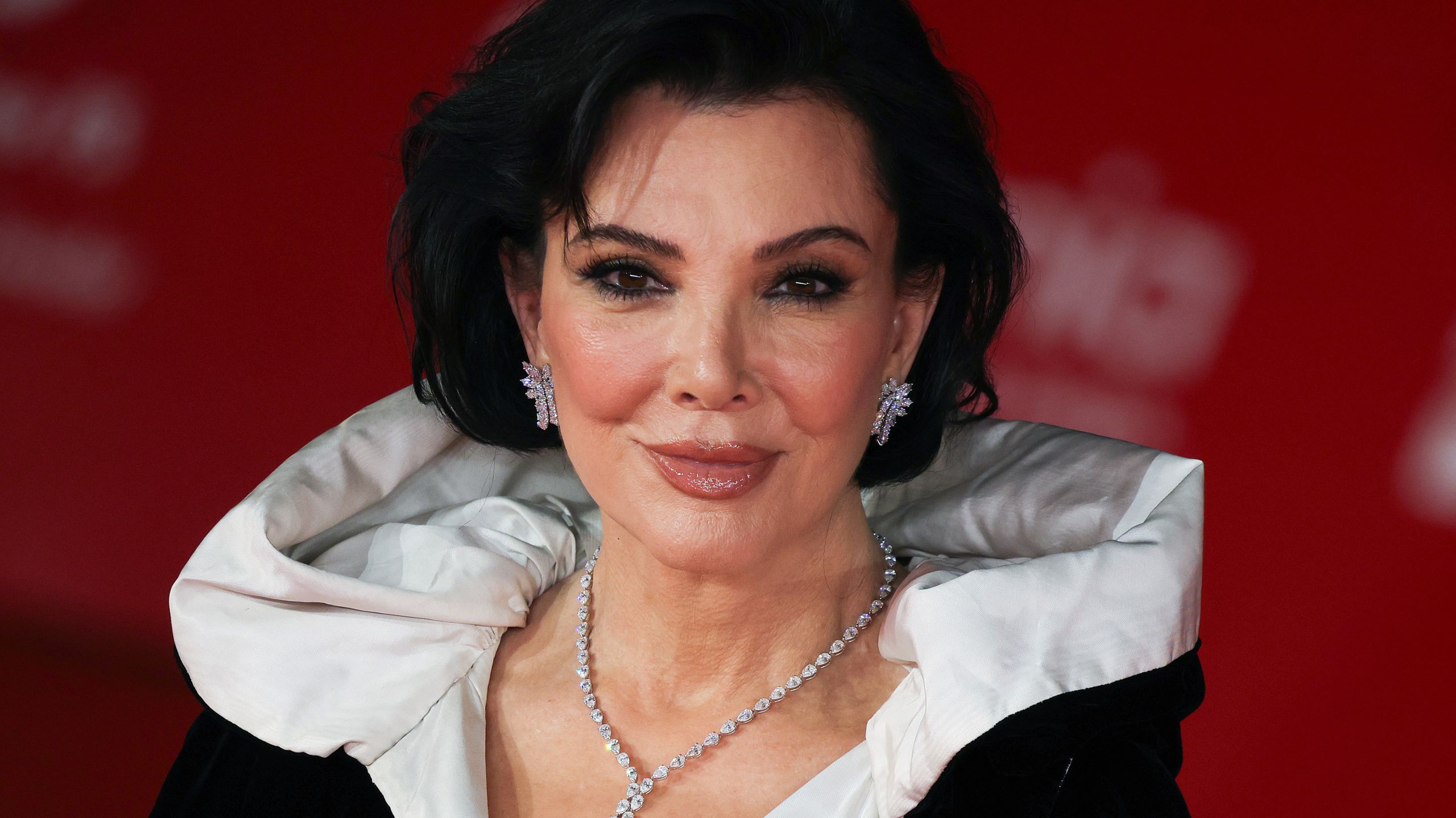 kris jenner on a red background