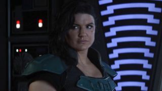 Cara Dune (Gina Carano) looks at an Imperial scientist on The Mandalorian.