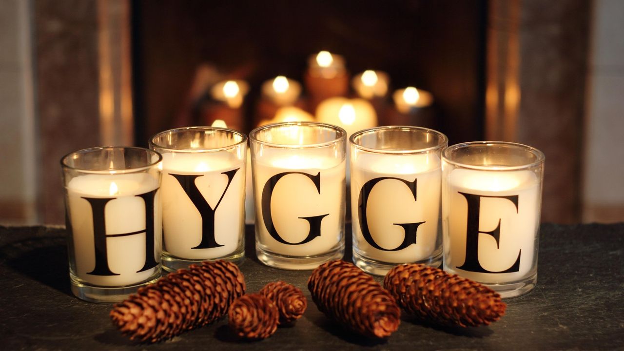 How to make candles last longer, Fireside candles in an English home in winter depict &#039;hygge&#039; - the Danish concept of embracing cosy contentment and conviviality