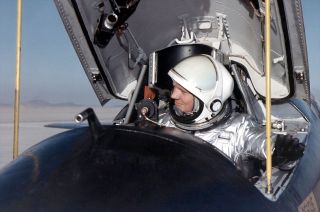 NASA research pilot Neil Armstrong is seen here in the cockpit of one of the three X-15 rocket planes after a research flight.