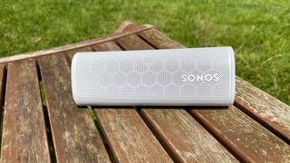 Sonos Roam on a wooden chair outside