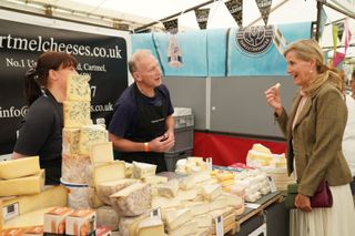 Sophie Wessex eating cheese at a stall at Westmoreland County Show