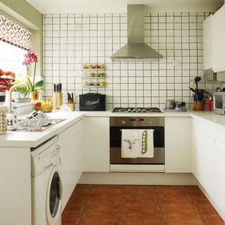kitchen room with white retro tiles and steel chimney