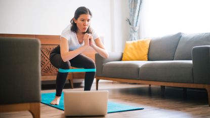 Woman doing a full body resistance band workout