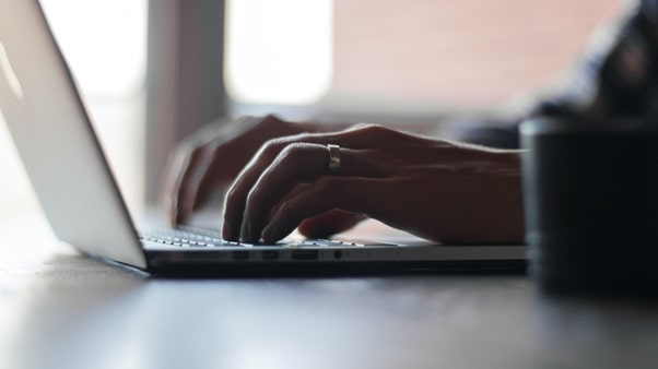 person typing at laptop on desk